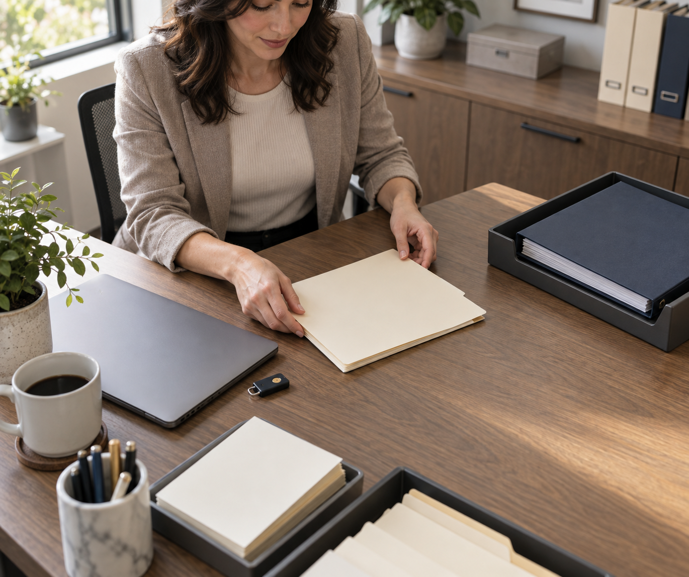 Billing administrator sorting folders at a desk while organizing Federal IDR Gateway transition paperwork.